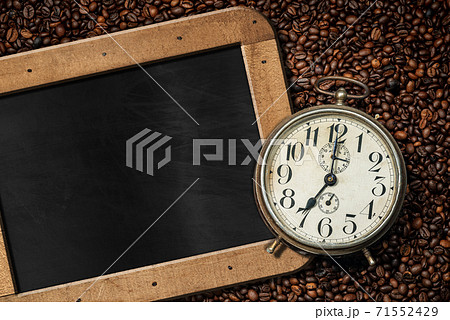 Alarm Clock on Roasted Coffee Beans and empty Blackboard 71552429