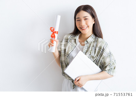Beautiful Asian girl holding diploma on so white 71553761