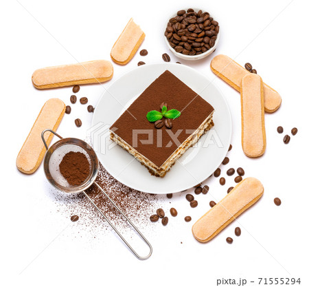 Traditional Italian Tiramisu dessert square portion on ceramic plate and savoiardi cookies isolated on white 71555294