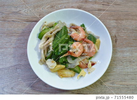 stir fried ridge gourd couple mushroom with baby corn in egg and shrimp on dish 71555480