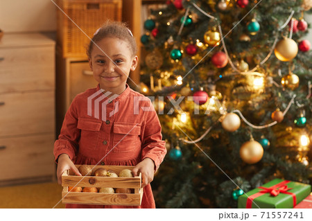 Happy African-American Girl by Christmas Tree Happy African-American Girl by Christmas Tree 71557241
