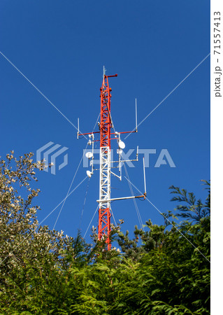 Red and white telecommunication antenna mast or mobile tower Red and white telecommunication antenna mast or mobile tower 71557413