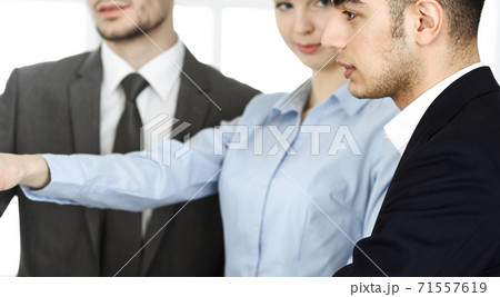 Group of business people discussing questions at meeting in office. Colleagues working with computer at workplace Group of business people discussing questions at meeting in office. Colleagues working with computer at workplace 71557619