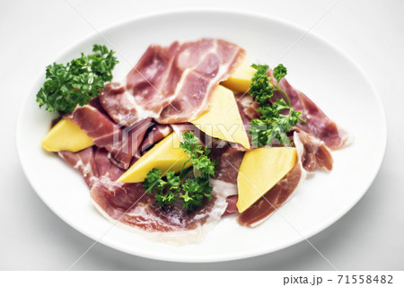 jamon serrano parma prosciutto style smoked ham with mango fruit 71558482