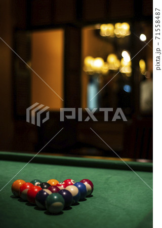 billiards balls on pool table in cozy dark bar interior billiards balls on pool table in cozy dark bar interior 71558487