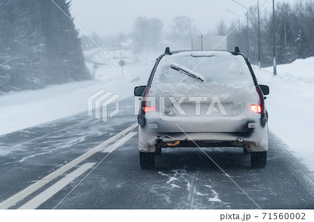Car is driving on a winter road Car is driving on a winter road 71560002