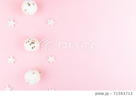 Christmas background with white balls, sequins on stylish pink table top view. Flat lay festive elegant composition 71563713