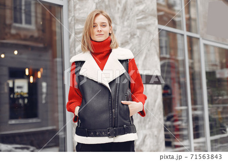 Winter time in big city of charming girl standing on street Winter time in big city of charming girl standing on street 71563843