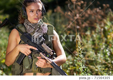 female hunter in camouflage waiting for opportunities to shoot 71564305