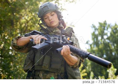 military woman is checking details of weapon military woman is checking details of weapon 71564576
