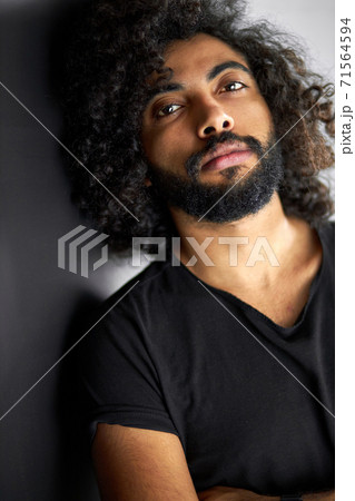 close-up portrait of handsome calm arab man in black shirt posing in studio 71564594