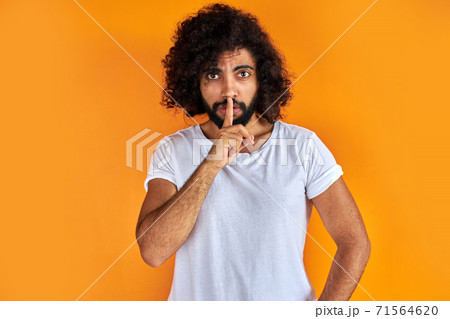 indian arabic male asking to be quiet with finger on lips indian arabic male asking to be quiet with finger on lips 71564620