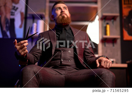 bearded macho man, barber male indoors 71565295