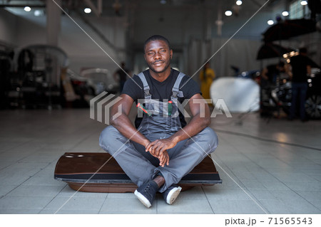 portrait of positive afro american auto mechanic in uniform portrait of positive afro american auto mechanic in uniform 71565543