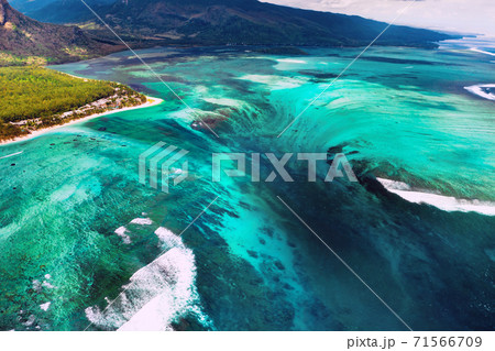 The view from the bird's eye view of the coral reef near the mountain Le Morne Brabant, a beautiful blue lagoon and the underwater waterfall 71566709