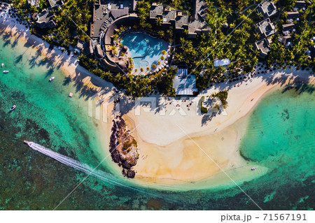Aerial picture of the east coast of Mauritius Island. Flying above the turquoise lagoon of Mauritius in the region of Belle Mare. 71567191