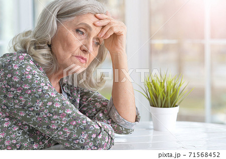 Portrait of beautiful sad senior woman at home 71568452