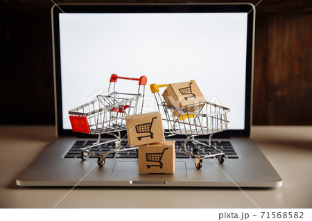 Boxes in a trollies on a laptop keyboard. Online shopping concept 71568582