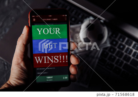 Lucky winner at football betting with phone in hand. Betting concept Lucky winner at football betting with phone in hand. Betting concept 71568618