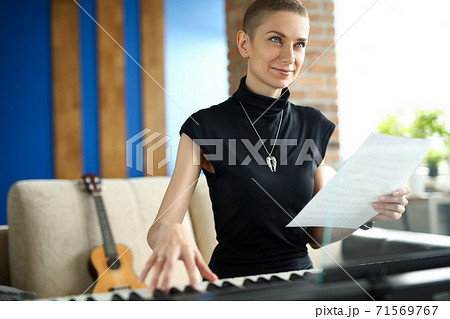 Musician holding paper with notes Musician holding paper with notes 71569767
