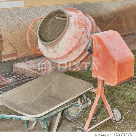 Concrete mixer and truck working to build a structure in a construction and rehabilitation work Concrete mixer and truck working to build a structure in a construction and rehabilitation work 71571470