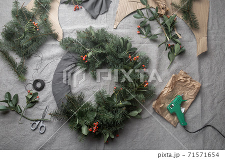 Making Christmas wreath. New year holiday decoration. Making Christmas wreath. New year holiday decoration. 71571654