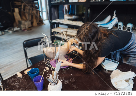 Portrait of young woman enjoying favorite job in workshop. Portrait of young woman enjoying favorite job in workshop. 71572205