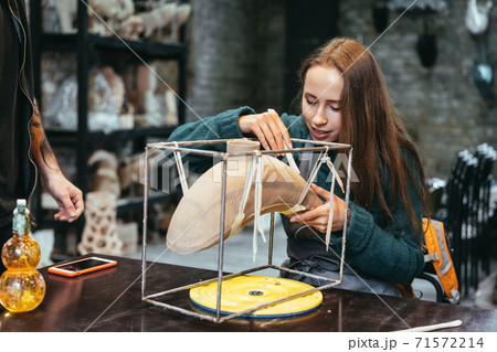 Portrait of young woman enjoying favorite job in workshop. Portrait of young woman enjoying favorite job in workshop. 71572214
