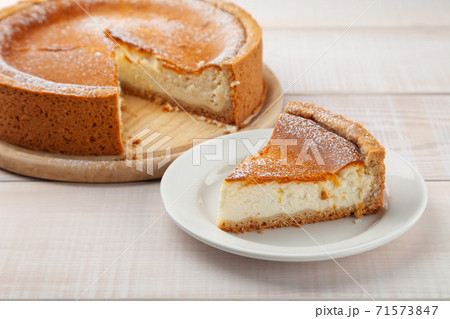 Homemade cheesecake and piece of pie near on plate Homemade cheesecake and piece of pie near on plate 71573847