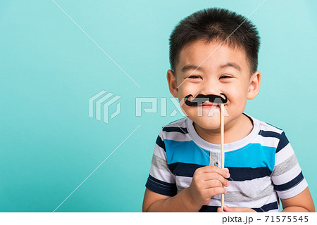 Funny happy hipster kid holding black mustache 71575545