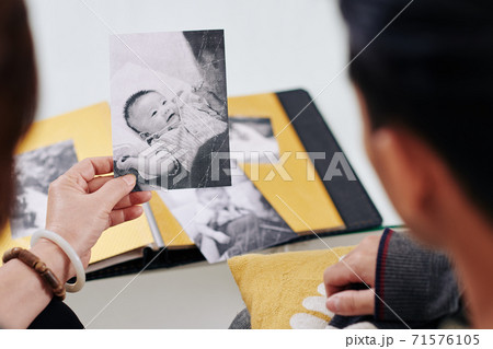 Mother showing old photo Mother showing old photo 71576105