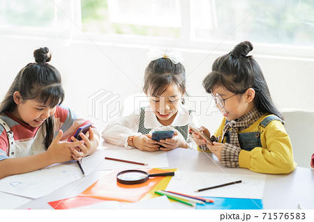Children using smartphone Children using smartphone 71576583
