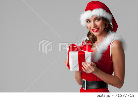Santa girl with Christmas gift 71577718