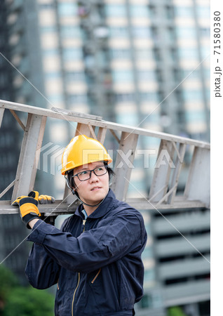 Maintenance worker man carrying aluminium ladder Maintenance worker man carrying aluminium ladder 71580380