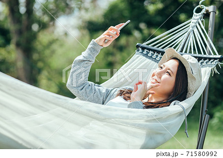 ハンモックで寝る女性の写真素材