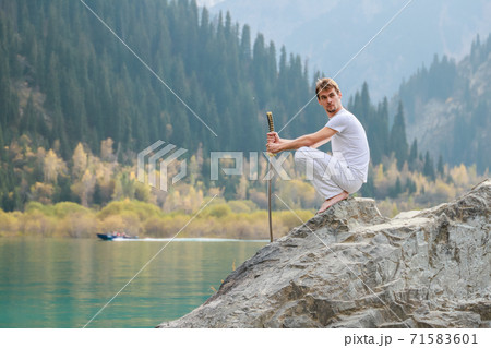 A man with a beard lowered his battle sword. Male defeat. A man with a beard lowered his battle sword. Male defeat. 71583601