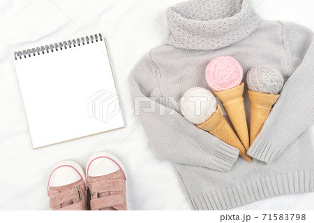 Three ice cream from yarn in waffle cones on gray knitted sweater, pink sneakers and open notepad on white background. Top view Flat lay Mockup Three ice cream from yarn in waffle cones on gray knitted sweater, pink sneakers and open notepad on white background. Top view Flat lay Mockup 71583798