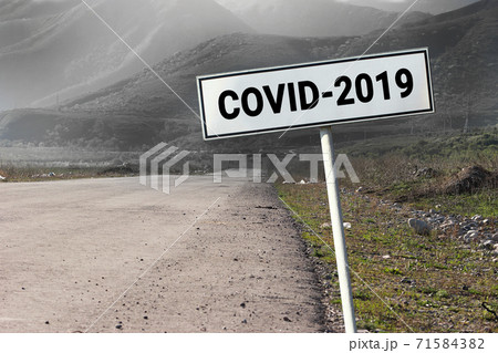 Road and road sign with word - Covid-2019. Danger travel coronavirus concept Road and road sign with word - Covid-2019. Danger travel coronavirus concept 71584382