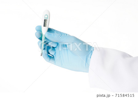 Close up hand in rubber latex medicine blue glove holding a electronic thermometer. 71584515