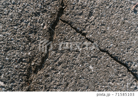 Texture of gray dry asphalt with cracks close up Texture of gray dry asphalt with cracks close up 71585103