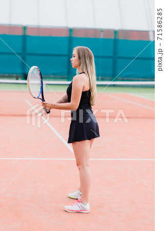 Tennis tournament. Female player at the clay tennis court Tennis tournament. Female player at the clay tennis court 71586285