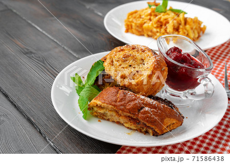 Georgian baked sweet nut roll with berry sauce 71586438