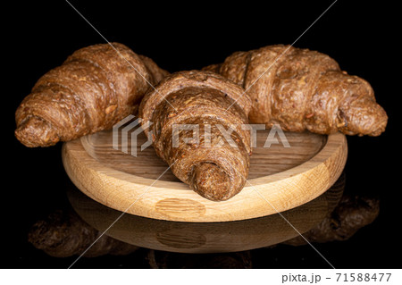 Baked croissant on black glass Baked croissant on black glass 71588477