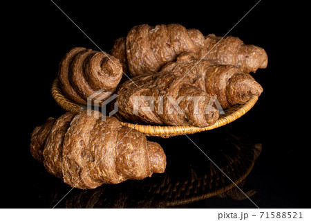 Baked croissant on black glass Baked croissant on black glass 71588521