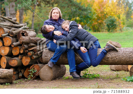 family relaxing outdoor in autumn city park, happy people together, parents and children, they lie on mother and sleep, beautiful nature family relaxing outdoor in autumn city park, happy people together, parents and children, they lie on mother and sleep, beautiful nature 71588932
