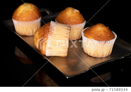 Baked muffin on black glass 71589334