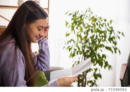 Woman opening, recieving greeting card for New Year and Christmas 2021 from friends or family Woman opening, recieving greeting card for New Year and Christmas 2021 from friends or family 71590563