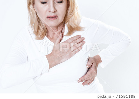 A woman feels pain in her chest, her heart aches. 71591188