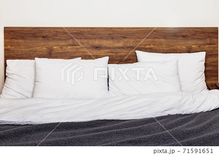 Modern bedroom interior. Bed with wooden headboard 71591651