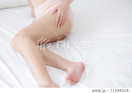 Beautiful young asian woman touch skin leg smooth with cream and lotion for hydration and smooth. Beautiful young asian woman touch skin leg smooth with cream and lotion for hydration and smooth. 71594328